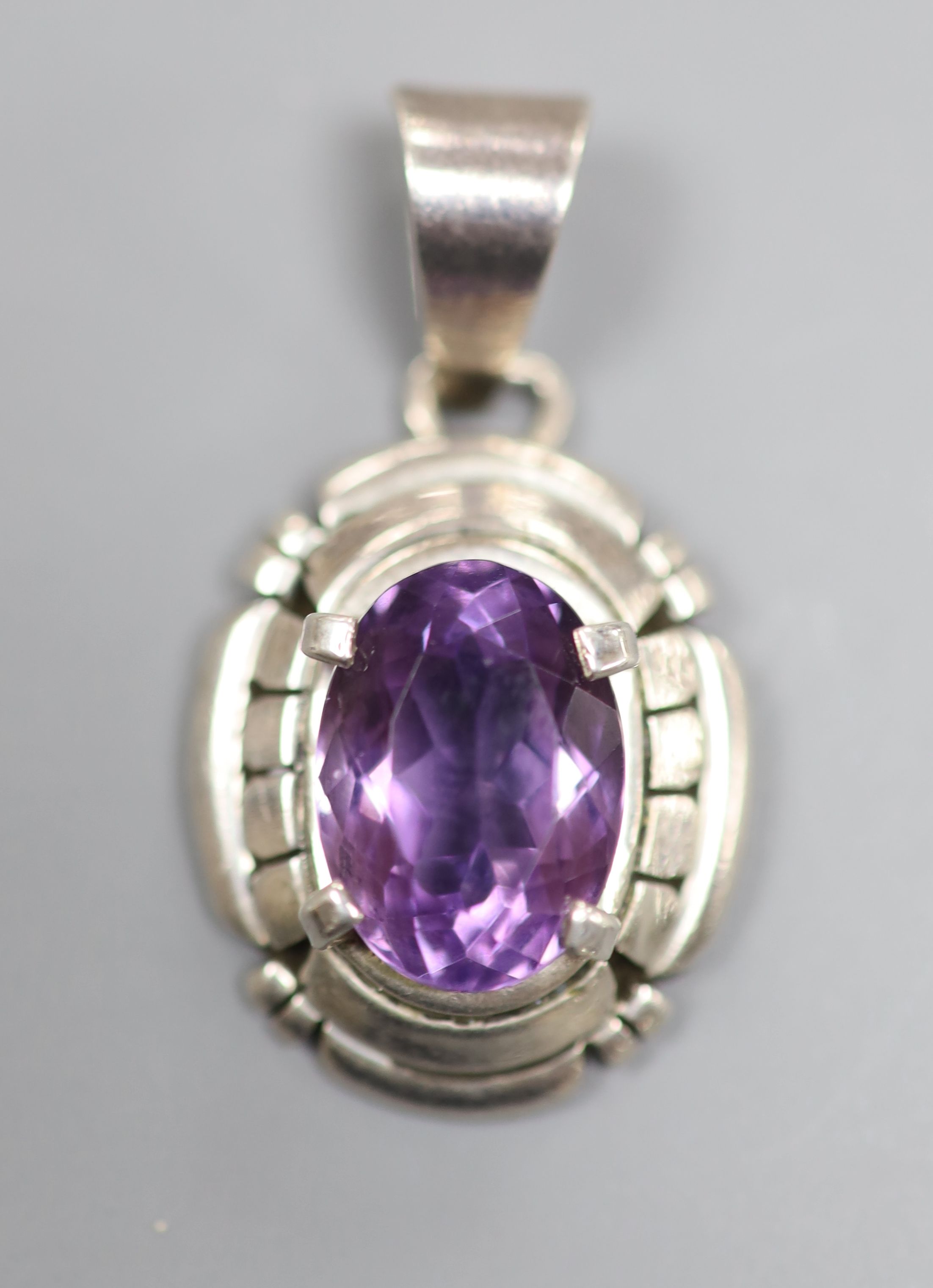 A continental sterling and amethyst set oval pendant, signed Carl Quintana